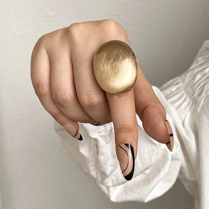 Gold tone oval mood ring with textured, brushed finish