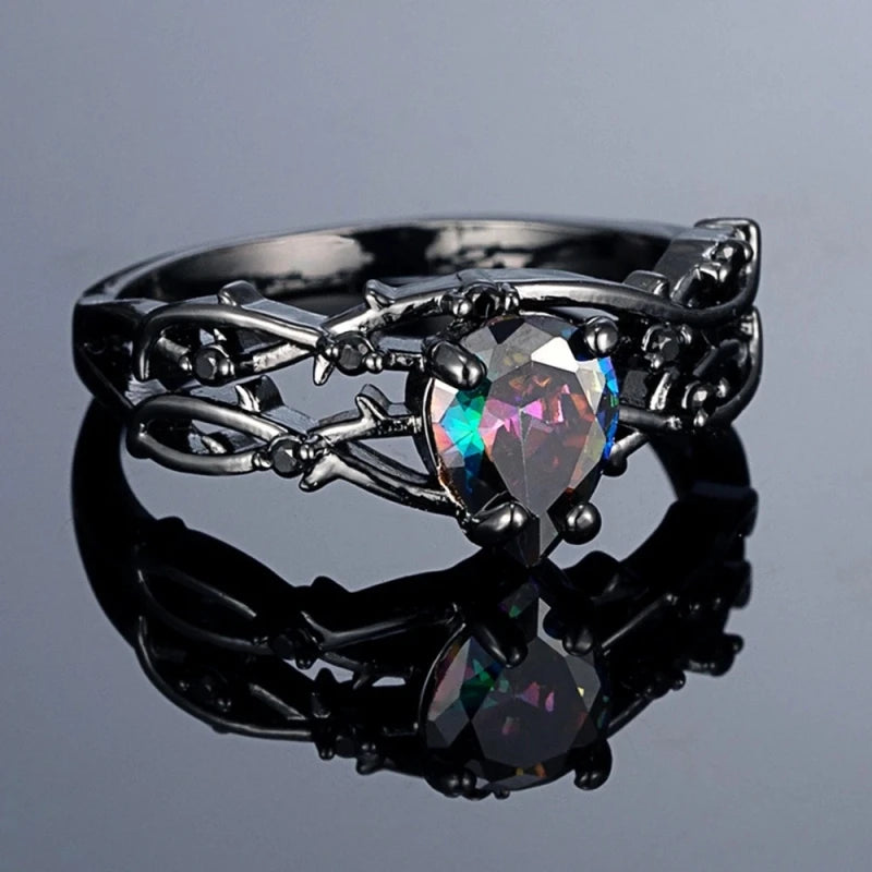 Black zinc alloy ring with multicolor faceted center stone and swirl floral side details