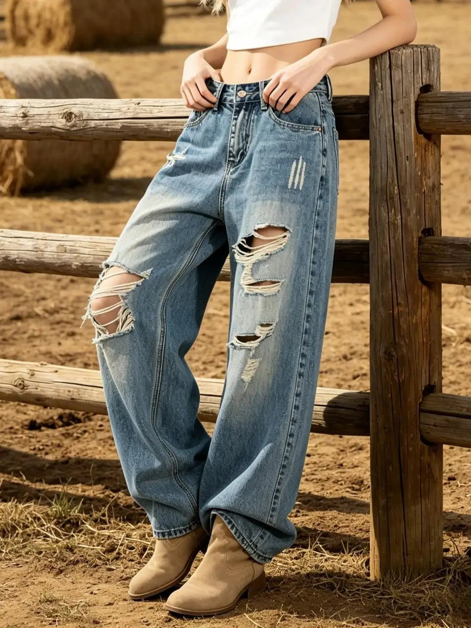Women’s high-waist light blue relaxed jeans with ripped knees and frayed distressed rips