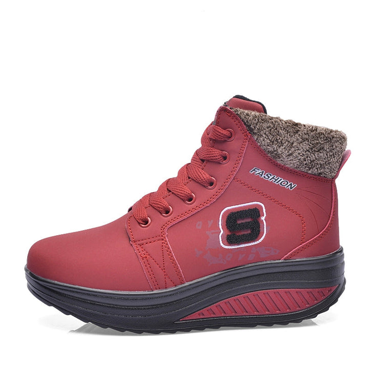 Red sneaker with fur lining on a white background, featuring the brand 'NEDKING EAST'.