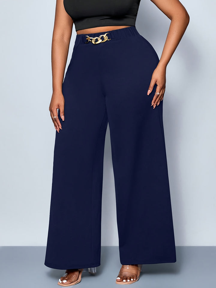 Navy wide-leg pants with a gold belt on a plain background