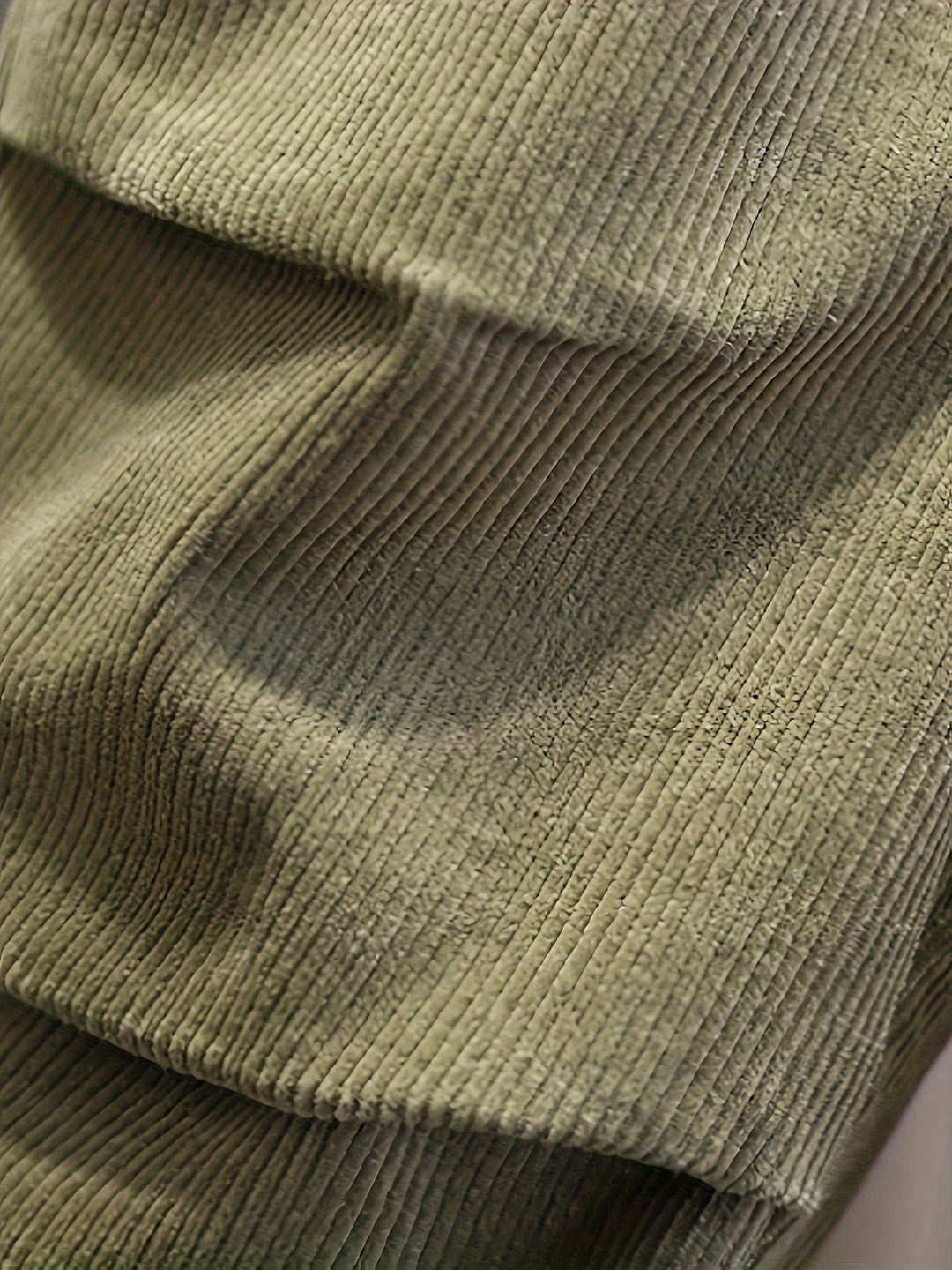 Close-up of a green ribbed sweater fabric