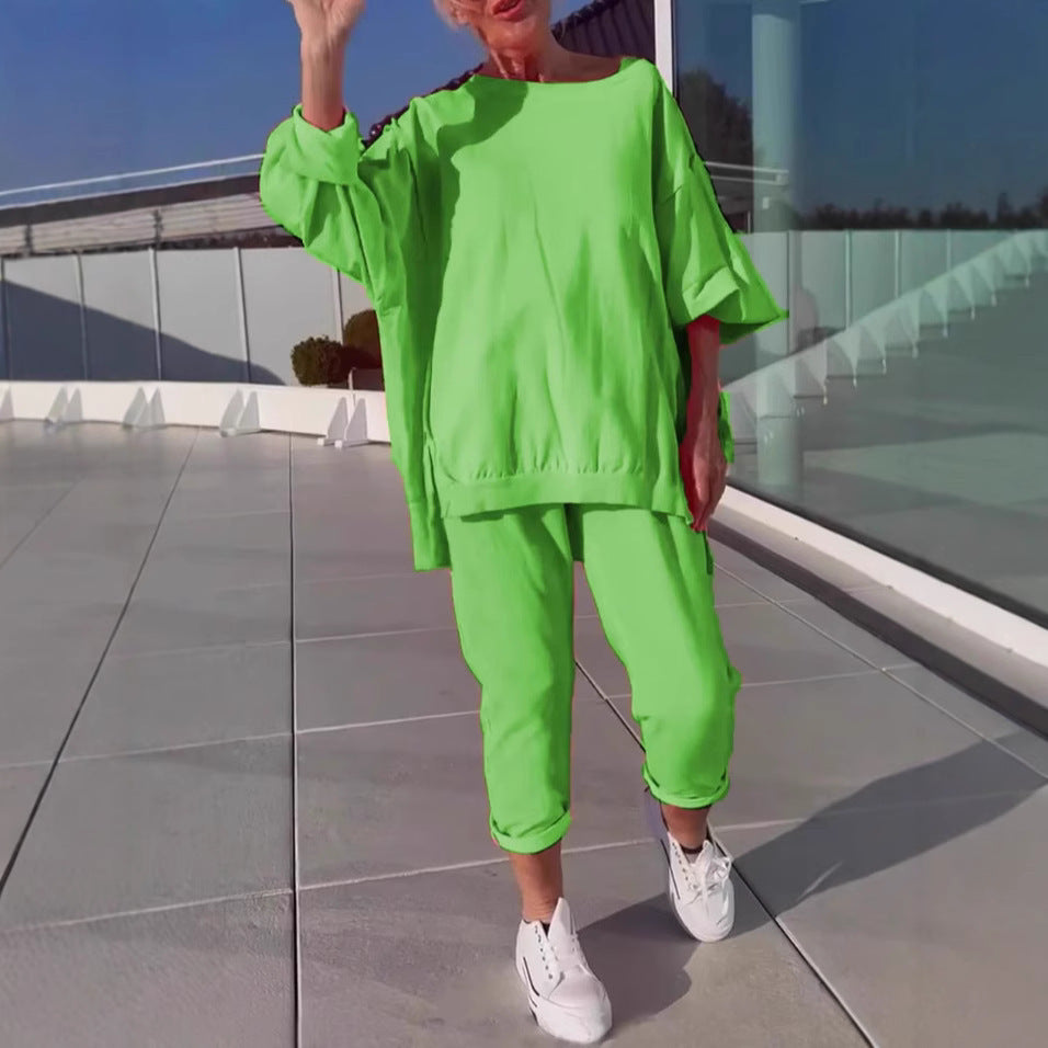 Person wearing a bright green outfit with white sneakers on a reflective floor.