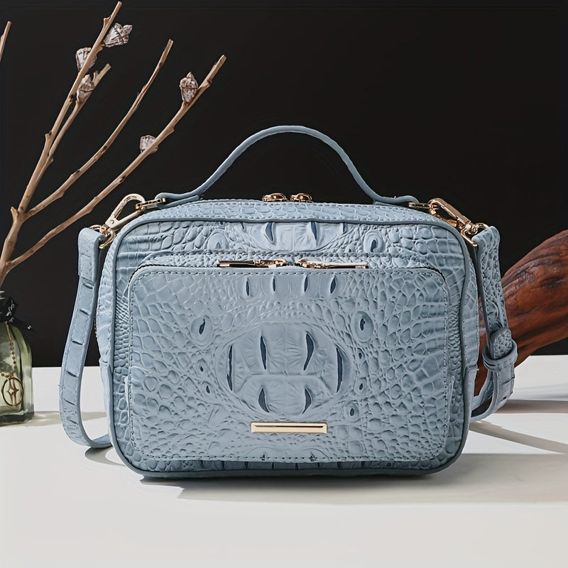 Blue textured handbag with gold accents on a dark background