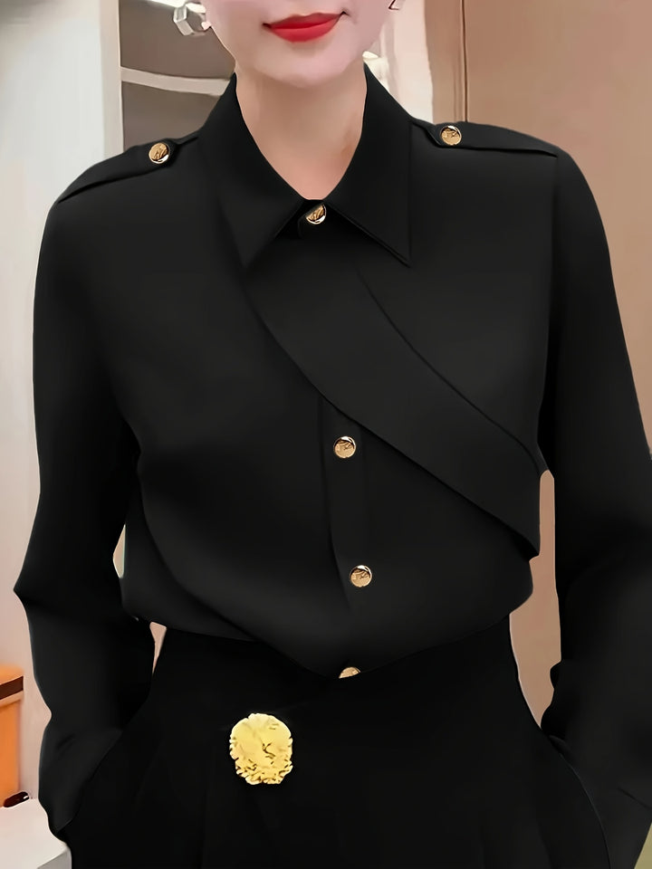 Person wearing a black coat with gold buttons and details.