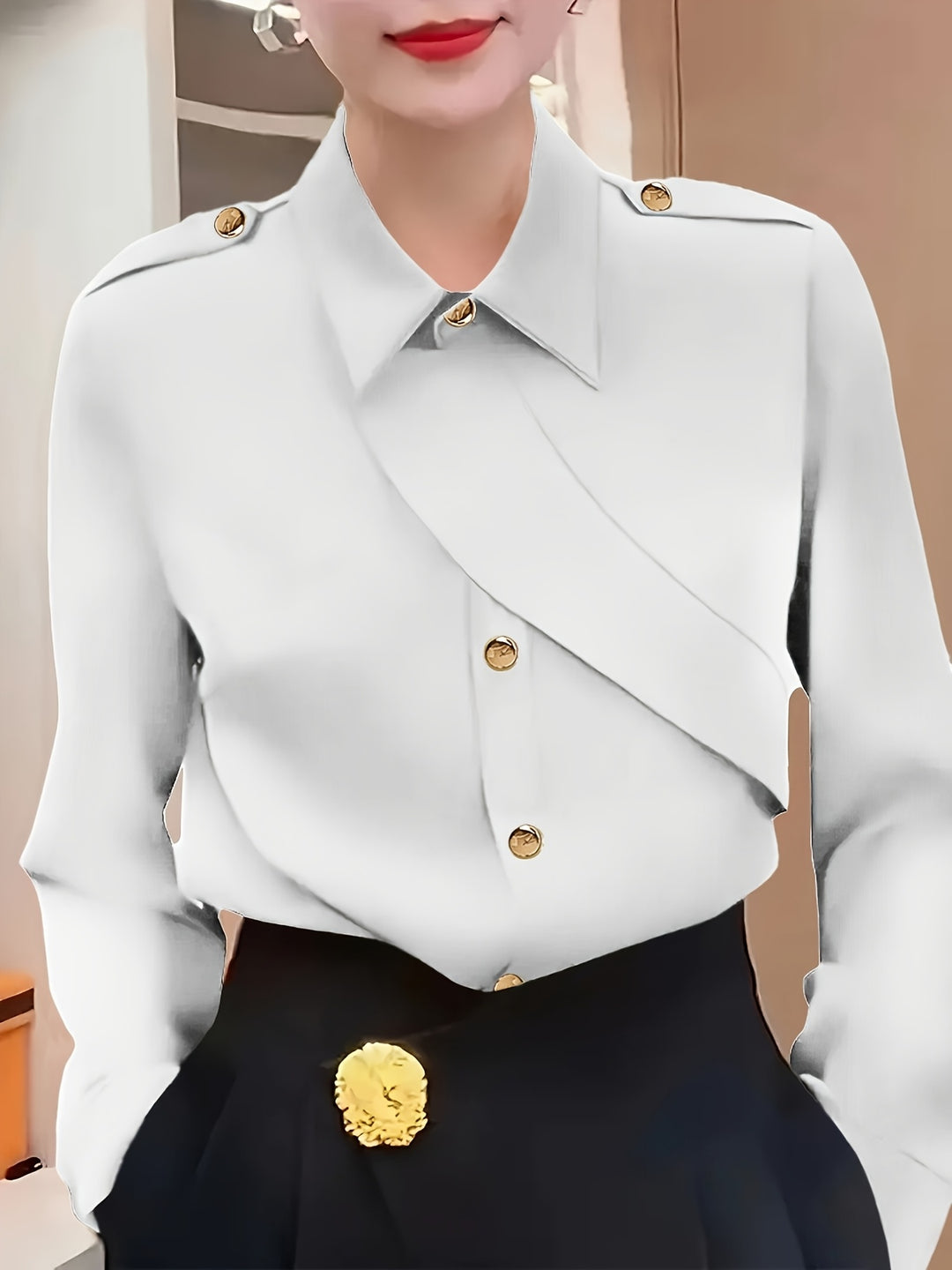 White blouse with gold buttons and black pants worn by a person.