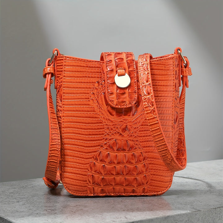 Orange textured handbag on a gray background