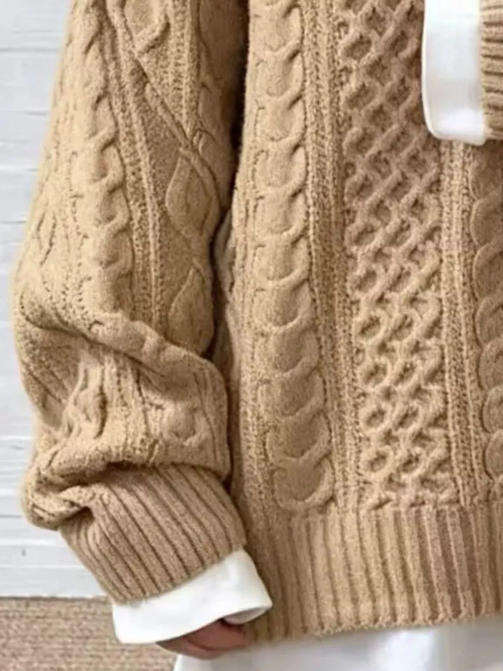 Beige cable-knit sweater close-up with cable cable patterns and ribbed sleeve cuff