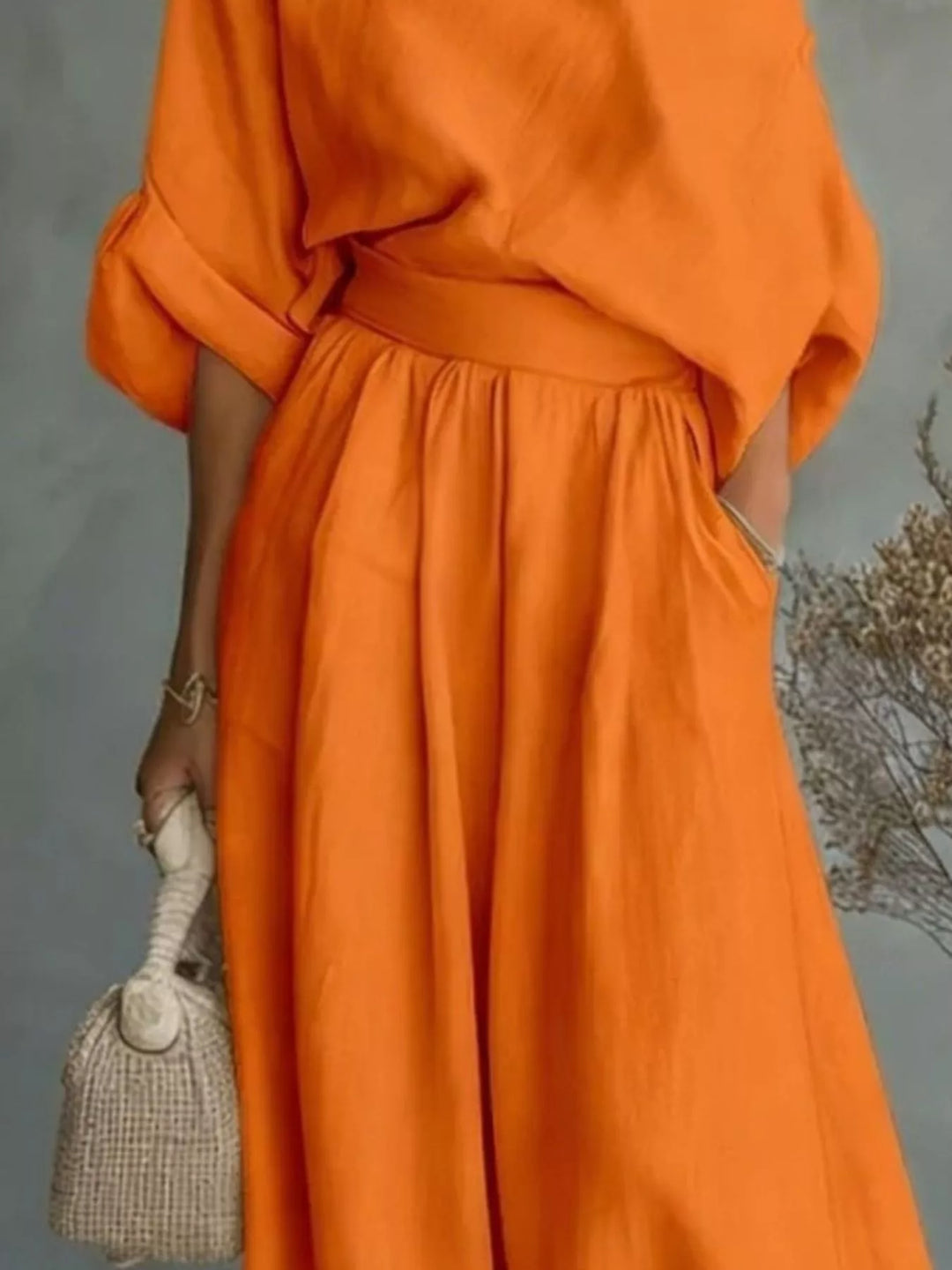 Orange one-shoulder top and wide-leg pants set with loose gathered waist and full-length