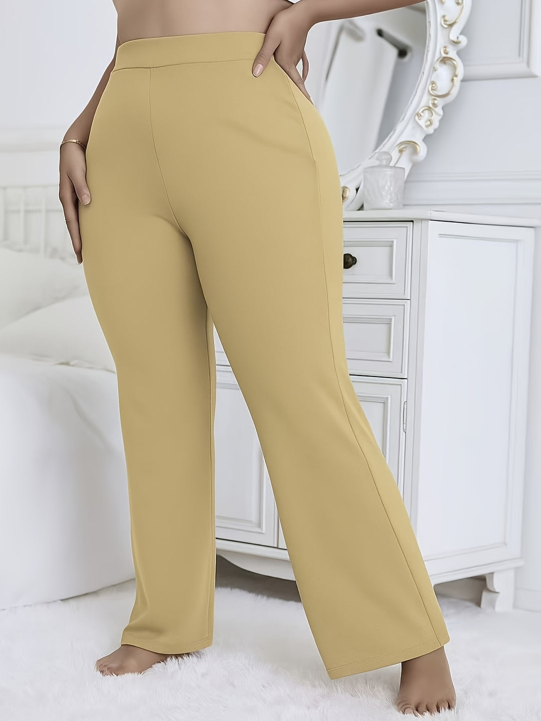 Mustard yellow pants worn by a person in a bedroom setting.