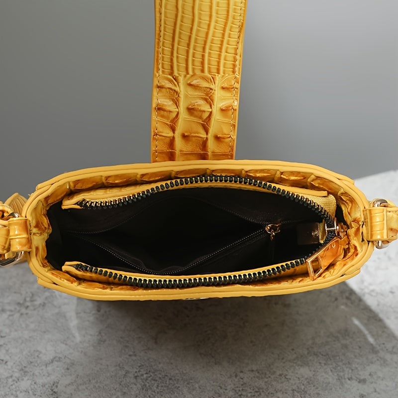 Yellow textured handbag with open zipper on a gray surface