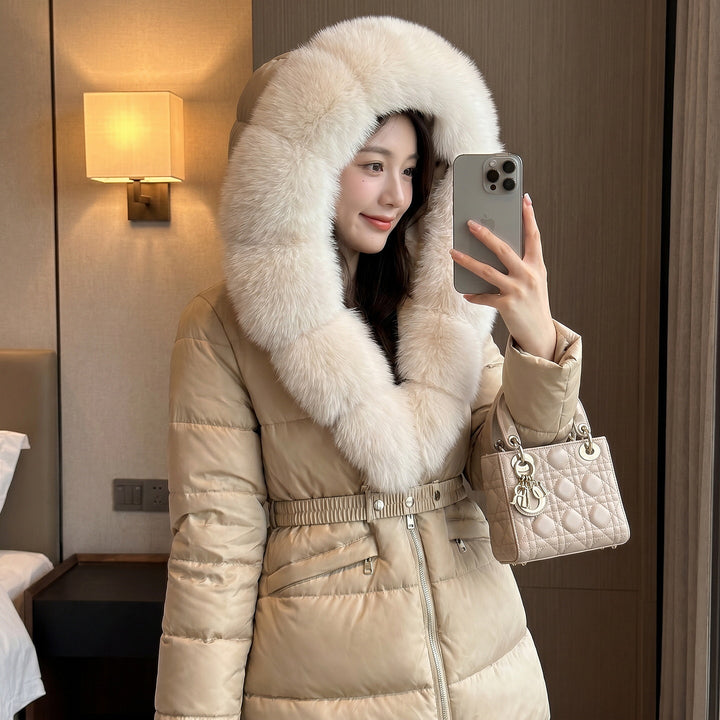 Women’s Khaki Hooded Puffer Coat Showing Cream Fur Collar, Belted Waist And Quilted Sleeves.