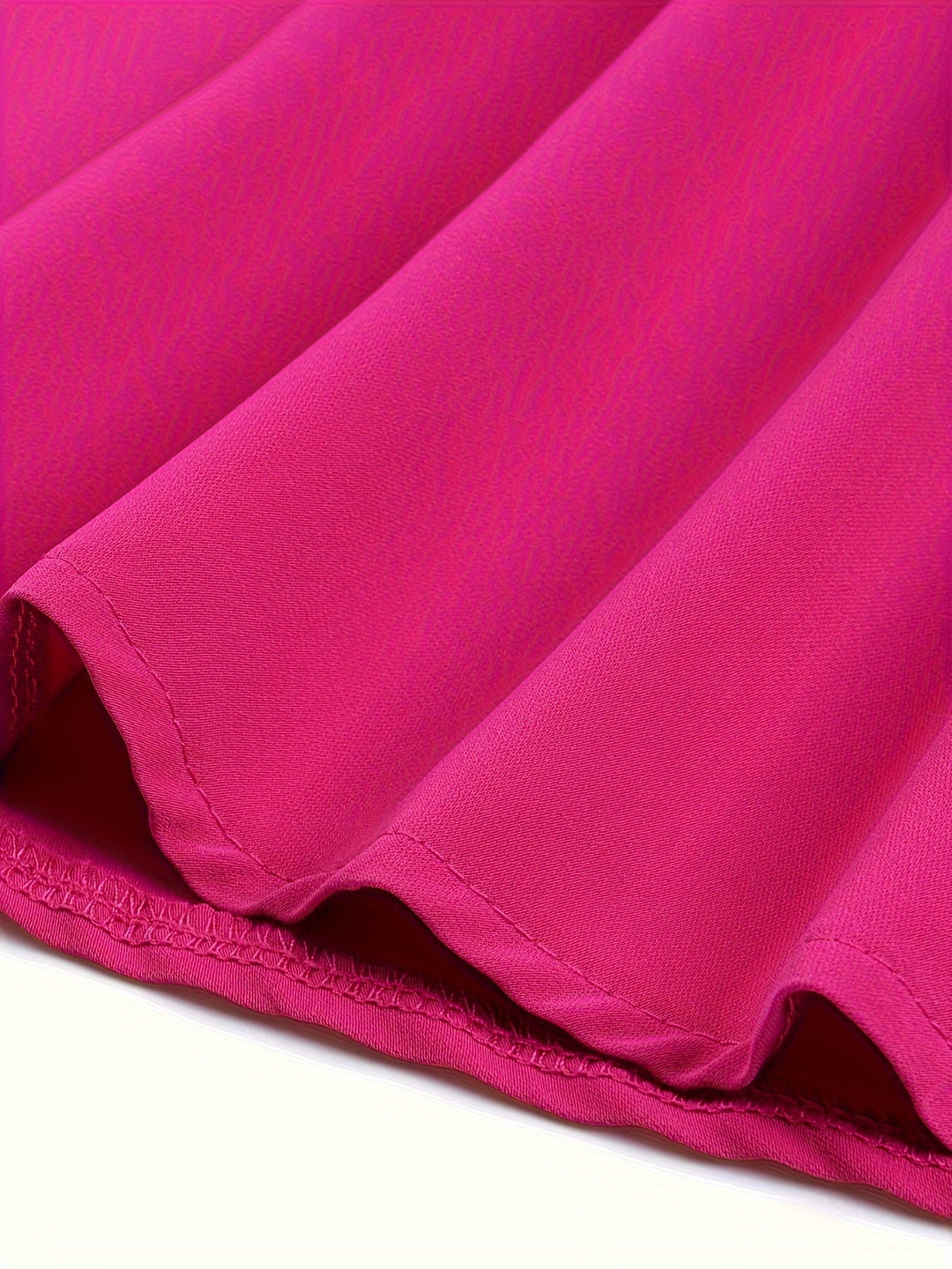 Close-up of a pink fabric with folds on a white background