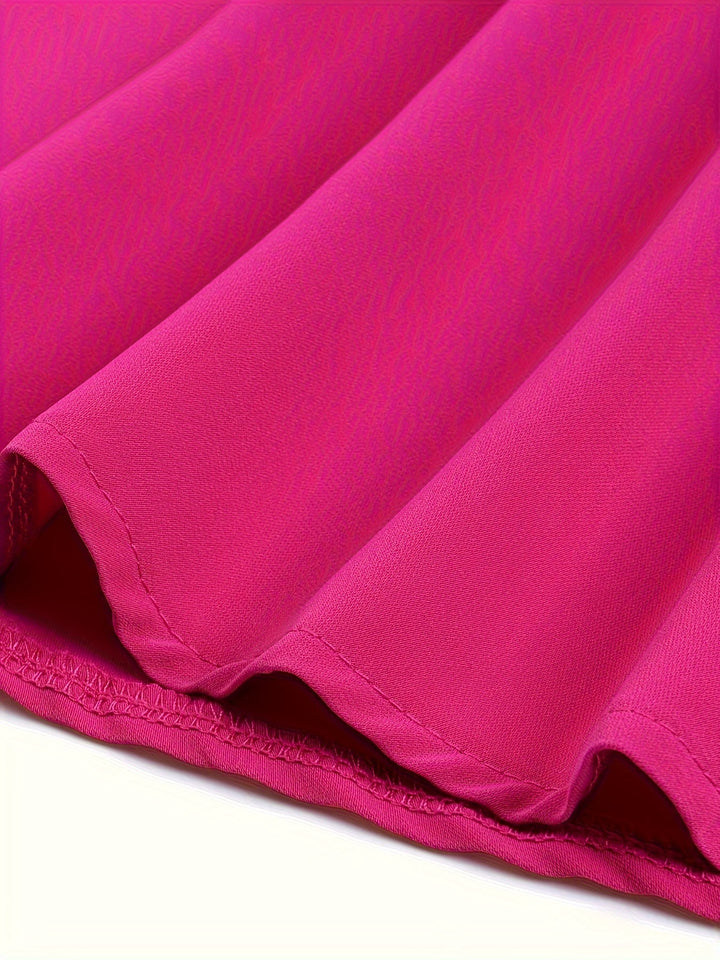 Close-up of a pink fabric with folds on a white background