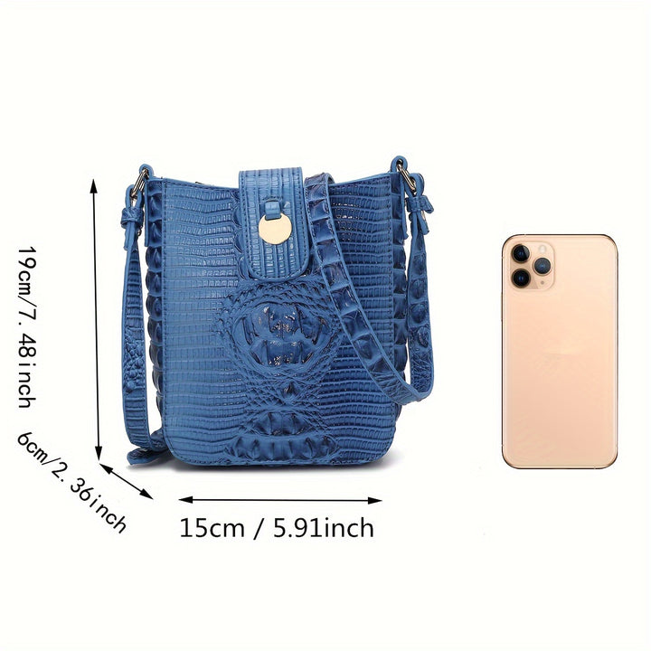 Blue textured handbag with measurements and a phone for scale on a white background