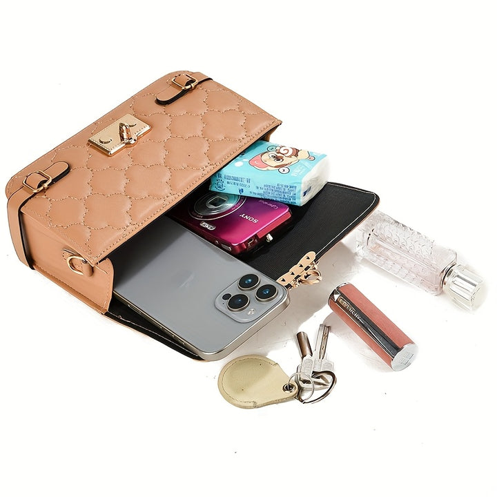 Open beige handbag with phone, items, and key displayed on a white background