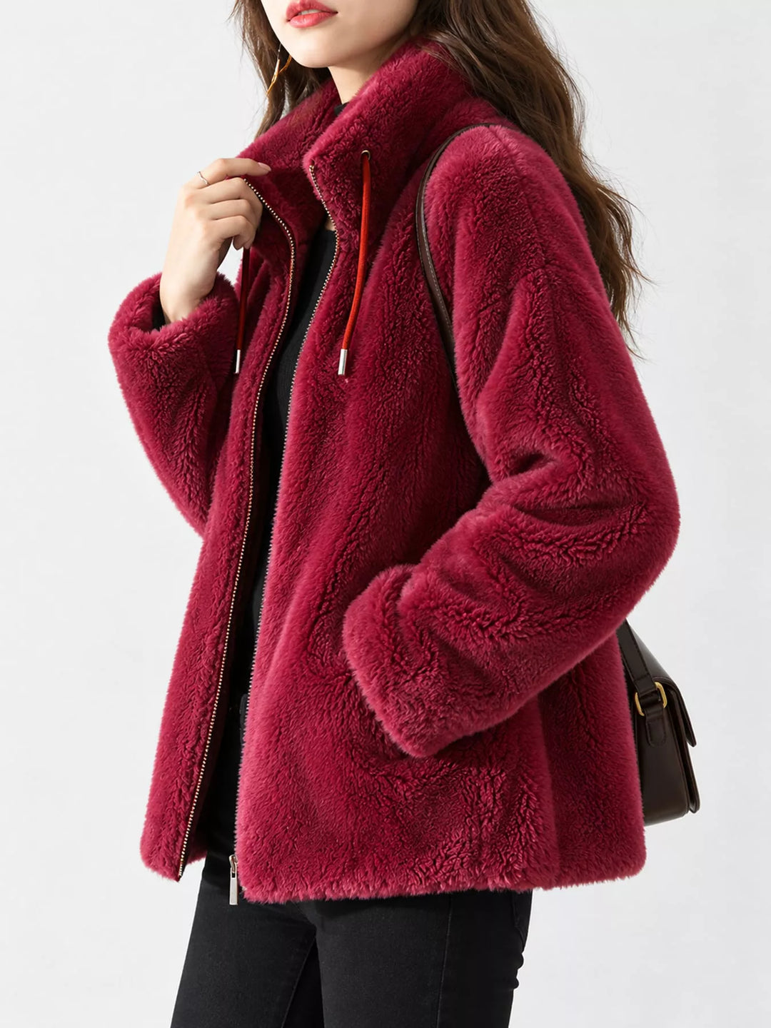 Burgundy faux fur zip jacket with stand collar and long sleeves, side view