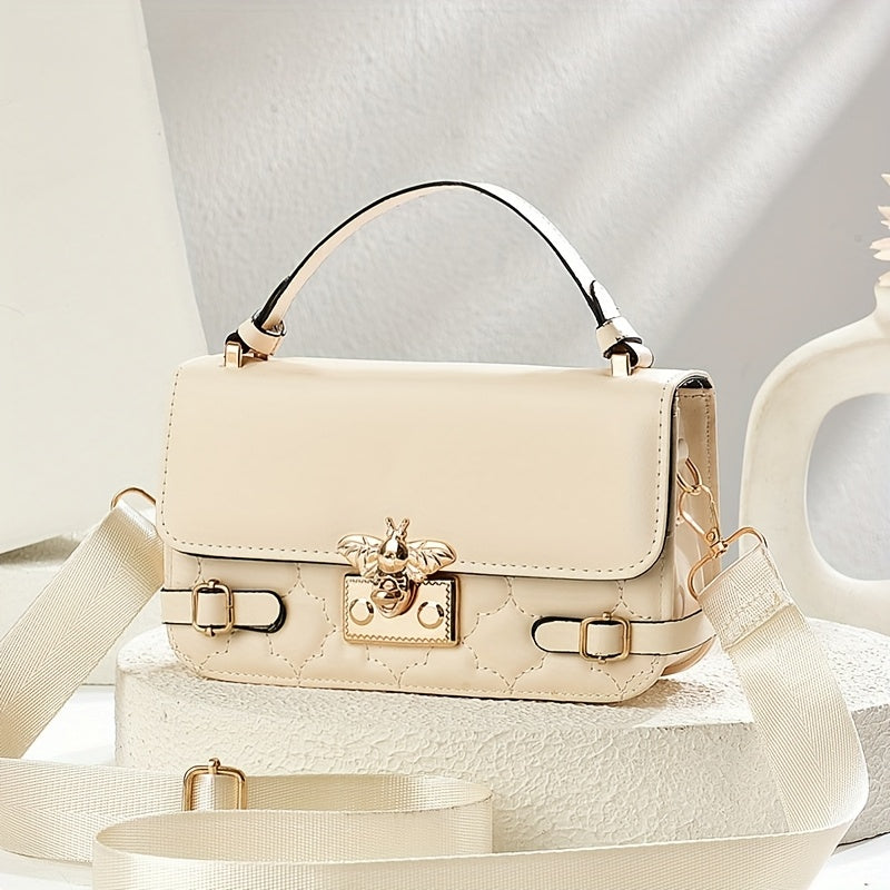 Beige handbag with gold accents on a light background