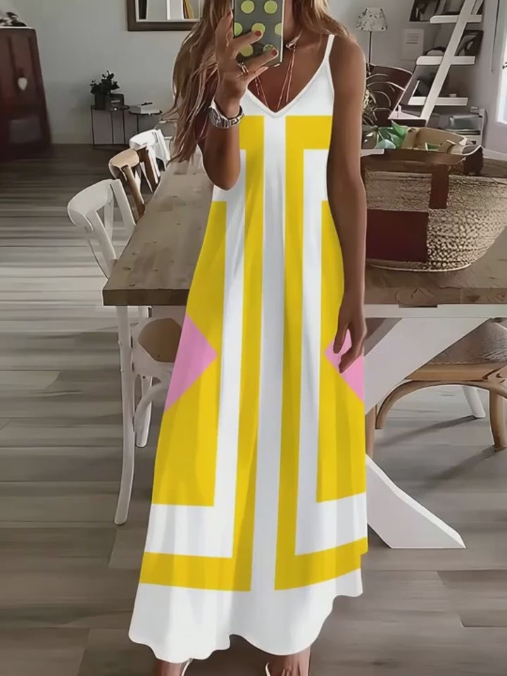 Video of a Person wearing a yellow and white dress with geometric patterns in a dining room.