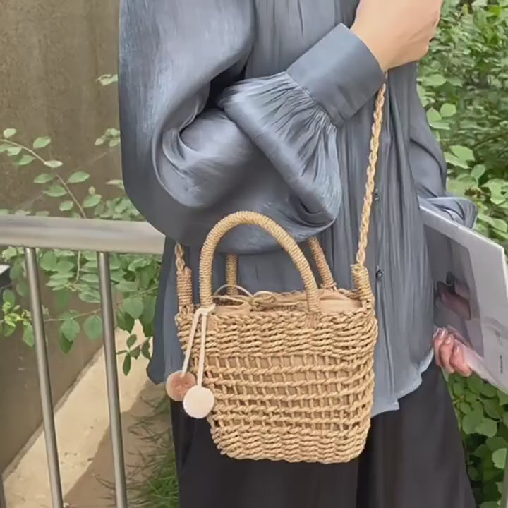Video of a Boho Luxe Bucket Bag — Knit Straw Crossbody With Bow Detail In Khaki & Beige